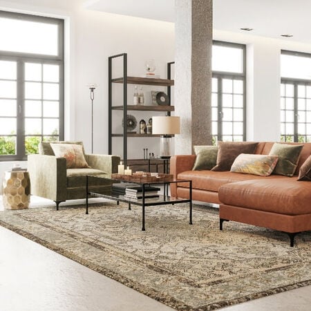 Living room with green armchor, glass coffee table, and brown leather chair