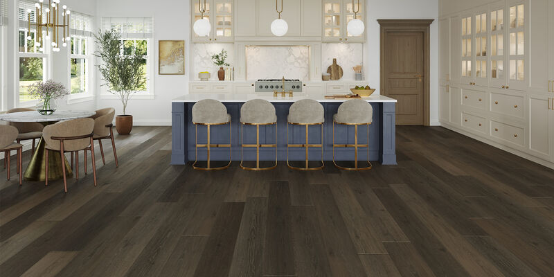 Lifestyle image with blue island and white counter tops in a kitchen with a luxury vinyl floor in oak-aged bronze