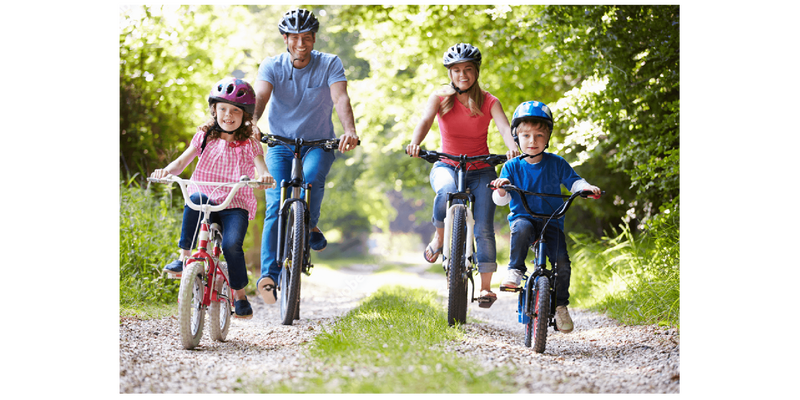Family of four riding bicycles