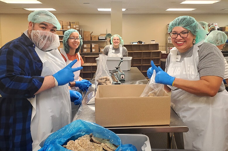 NFM employees helping bag lunches for kids in need